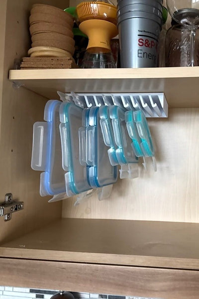 Customer photo — LidLoft 10-Slot organizer holding food-storage lids under a wood cabinet shelf