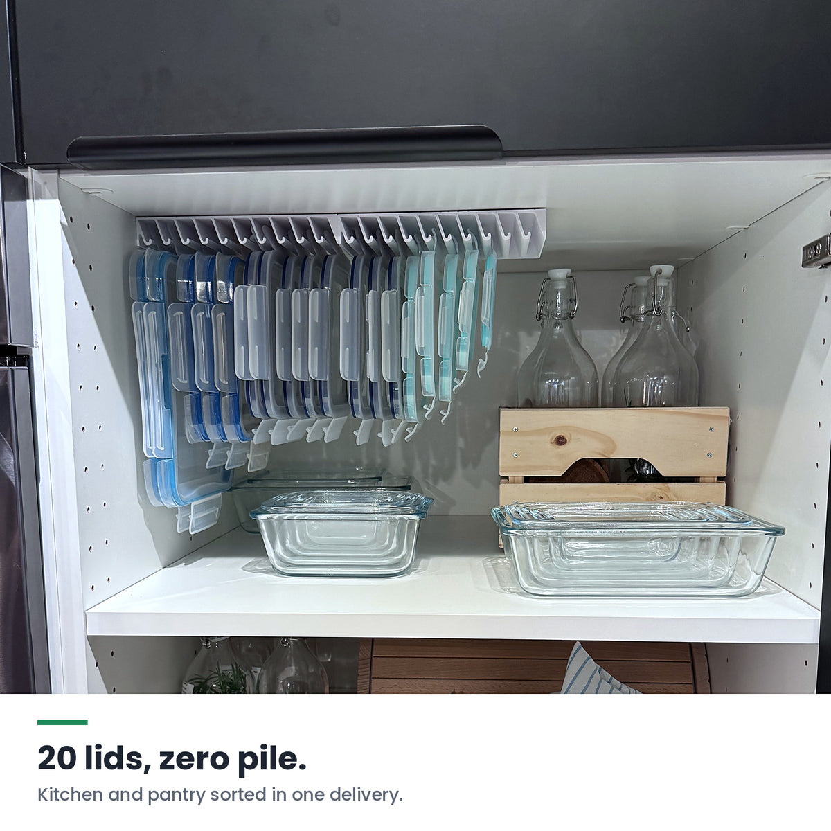 Open kitchen cabinet with two LidLoft organizers under the top shelf and glass containers below — 20 lids, zero pile