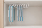 A hand slides one food-storage lid out of the LidLoft 10-Slot under-shelf organizer — grab and go