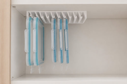 A hand slides one food-storage lid out of the LidLoft 10-Slot under-shelf organizer — grab and go